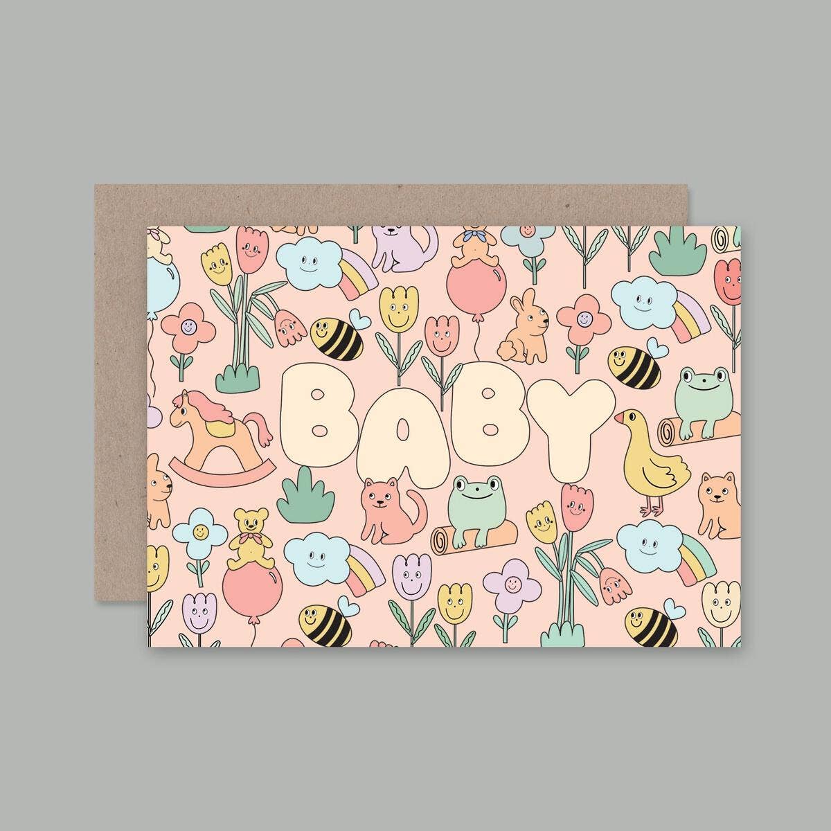 A greeting card with a colorful illustration of various cartoon animals and plants with the word 'BABY' in bold letters.