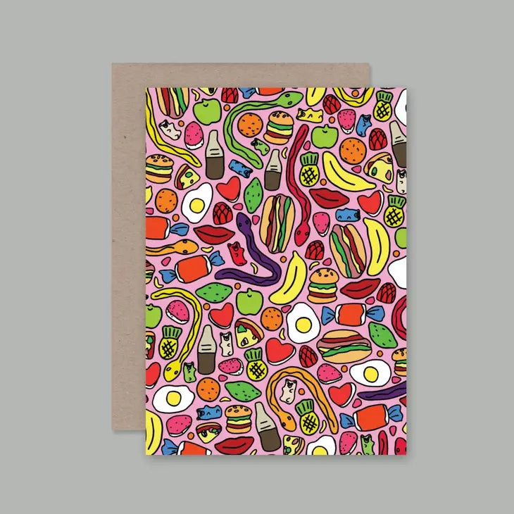 A colorful greeting card with a playful design featuring various cartoon food items and animals on a beige background, paired with a recycled paper envelope.