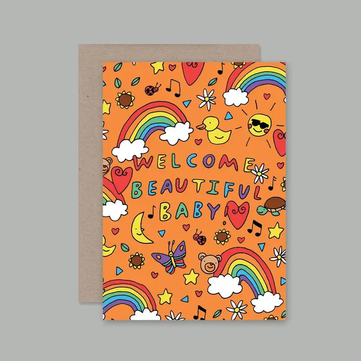 A colorful A6 greeting card with a front cover design featuring a rainbow, clouds, a bear, a moon, and musical notes, with the text 'Welcome Beautiful Baby'.
